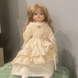 Cream dress on porcelain White Doll with blonde hair with stand